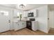 Clean kitchen featuring white cabinets and flooring at 1743 W Verde Ln, Phoenix, AZ 85015