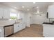 Open concept kitchen features white cabinets, stainless steel appliances, and a dining area at 1743 W Verde Ln, Phoenix, AZ 85015