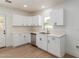 Bright kitchen with white cabinets, stainless steel appliances, and light countertops at 1743 W Verde Ln, Phoenix, AZ 85015