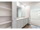 Double vanity bathroom with white cabinets and marble countertop at 17826 W Sanna St, Waddell, AZ 85355