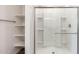 Shower with glass door and built-in shelving at 17826 W Sanna St, Waddell, AZ 85355