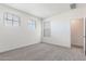 Spacious bedroom with gray carpet and two windows at 17826 W Sanna St, Waddell, AZ 85355