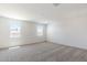 Bright bedroom featuring two windows and carpeted floors at 17826 W Sanna St, Waddell, AZ 85355