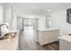 Kitchen with island and pantry, open to living area at 17826 W Sanna St, Waddell, AZ 85355