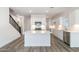 Modern kitchen with white cabinets and island at 17826 W Sanna St, Waddell, AZ 85355