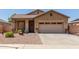 Single-story house with a two-car garage and nicely landscaped yard at 1825 N Lewis Pl, Casa Grande, AZ 85122