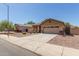 Single-story house with a two-car garage and desert landscaping at 1825 N Lewis Pl, Casa Grande, AZ 85122