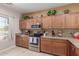 Modern kitchen with stainless steel appliances and wood cabinets at 1825 N Lewis Pl, Casa Grande, AZ 85122