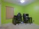 Green bedroom with two desks and chairs at 18489 N Davis Dr, Maricopa, AZ 85138