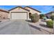 One-story house with a two-car garage and well-maintained landscaping at 18489 N Davis Dr, Maricopa, AZ 85138