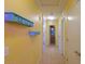 Hallway with light yellow walls and decorative shelves at 18489 N Davis Dr, Maricopa, AZ 85138