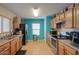 Kitchen with wood cabinets, stainless steel appliances, and blue walls at 18489 N Davis Dr, Maricopa, AZ 85138