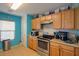 Kitchen with wood cabinets, stainless steel appliances, and blue walls at 18489 N Davis Dr, Maricopa, AZ 85138