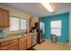 Kitchen with wood cabinets, stainless steel appliances, and blue walls at 18489 N Davis Dr, Maricopa, AZ 85138