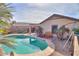 Large kidney shaped pool with a spacious backyard and covered patio at 18489 N Davis Dr, Maricopa, AZ 85138