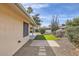 Pathway to backyard with artificial turf and desert plants at 18606 N Iona Ct, Sun City West, AZ 85375