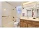 Clean bathroom featuring a shower/tub combo and wood vanity at 18606 N Iona Ct, Sun City West, AZ 85375