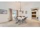 Dining area with a four-person table, chandelier, and access to the kitchen at 18606 N Iona Ct, Sun City West, AZ 85375