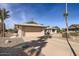 Front view of a house with a two-car garage and gravel driveway at 18606 N Iona Ct, Sun City West, AZ 85375