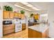 Kitchen with wood cabinets, granite countertops, and hardwood floors at 18606 N Iona Ct, Sun City West, AZ 85375