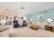 Spacious living room with light walls, neutral furniture, and a view into the dining area at 18606 N Iona Ct, Sun City West, AZ 85375