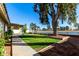 Spacious backyard with grassy area, mature trees, and a water view at 19037 N 73Rd Ln, Glendale, AZ 85308