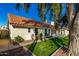 Landscaped backyard showcasing a large grassy area and home exterior at 19037 N 73Rd Ln, Glendale, AZ 85308