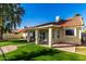 Home exterior view, showcasing a covered patio and well-maintained lawn at 19037 N 73Rd Ln, Glendale, AZ 85308