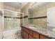 Bathroom with granite vanity and a shower/tub combo at 19037 N 73Rd Ln, Glendale, AZ 85308