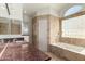 Bathroom with granite vanity and a large bathtub at 19037 N 73Rd Ln, Glendale, AZ 85308