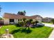 House exterior showcasing a well-maintained lawn and attractive landscaping at 19037 N 73Rd Ln, Glendale, AZ 85308