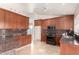 Modern kitchen featuring dark wood cabinets and granite countertops at 19037 N 73Rd Ln, Glendale, AZ 85308