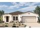 One-story home with Spanish-style architecture, two-car garage, and desert landscaping at 19320 W Missouri Ave, Litchfield Park, AZ 85340