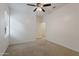 Bright bedroom with ceiling fan and window at 20249 W Woodlands Ave, Buckeye, AZ 85326