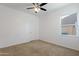 Well-lit bedroom with ceiling fan and window at 20249 W Woodlands Ave, Buckeye, AZ 85326