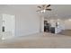 Spacious living room with ceiling fan and carpet flooring at 20249 W Woodlands Ave, Buckeye, AZ 85326