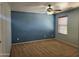 Spacious bedroom with blue accent wall and ceiling fan at 20356 N 261St Dr, Buckeye, AZ 85396