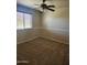 Bright bedroom featuring ceiling fan and neutral carpeting at 20356 N 261St Dr, Buckeye, AZ 85396