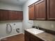 Laundry room with cabinets and a utility sink at 20356 N 261St Dr, Buckeye, AZ 85396