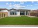 This home features a well-manicured backyard with lush green grass and a covered patio at 21537 W Pierson St, Buckeye, AZ 85396