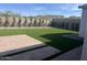 A well-maintained backyard with an expansive lawn and a paved patio area at 21537 W Pierson St, Buckeye, AZ 85396