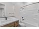 Clean bathroom with wood vanity, white countertop, and shower and bath combo at 21537 W Pierson St, Buckeye, AZ 85396