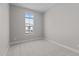Neutral bedroom featuring carpet flooring, white baseboards and a bright window at 21537 W Pierson St, Buckeye, AZ 85396