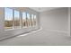 Bright bedroom with large windows and neutral carpeting at 21537 W Pierson St, Buckeye, AZ 85396