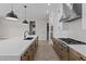 Modern kitchen features a quartz countertop island and stainless steel appliances at 21537 W Pierson St, Buckeye, AZ 85396