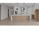 Modern kitchen boasts a large island, stainless steel appliances, and ample cabinet space at 21537 W Pierson St, Buckeye, AZ 85396