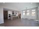 Open-concept living space with a modern kitchen and large windows providing natural light at 21537 W Pierson St, Buckeye, AZ 85396