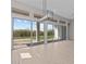 Living room with backyard view through sliding glass doors and transom windows at 21537 W Pierson St, Buckeye, AZ 85396