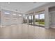 Bright open-plan living room with tile floors and sliding glass doors to the backyard at 21537 W Pierson St, Buckeye, AZ 85396