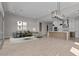 Open-concept living area with modern furnishings seamlessly connects to a stylish kitchen at 21537 W Pierson St, Buckeye, AZ 85396